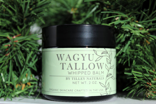 photo of wagyu tallow whipped balm with holiday greenery for gift giving